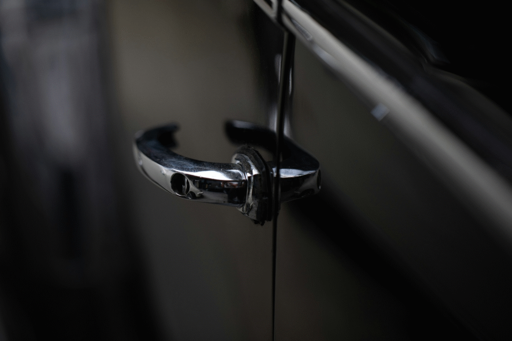 Broken car door handle on black vehicle