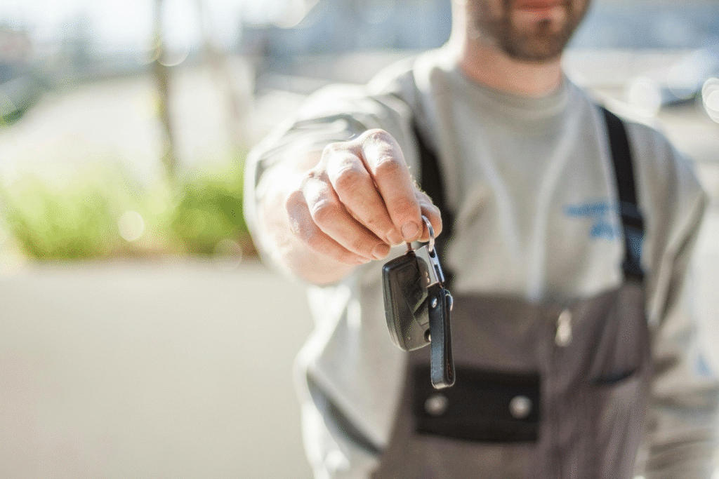 Mechanic handing car keys forward