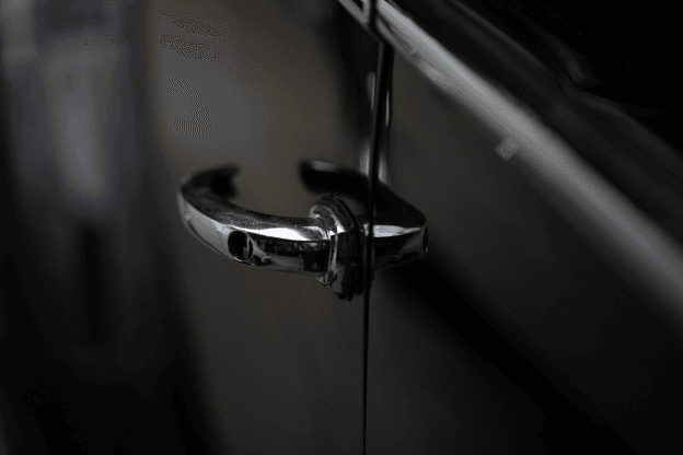 Broken car door handle on black vehicle