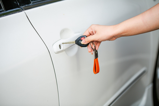 Hand unlocking white car door