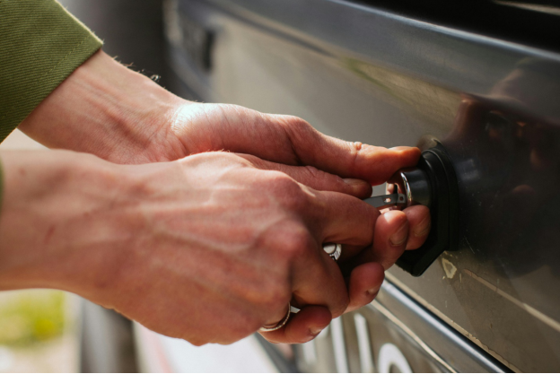 Person unlocking car with key